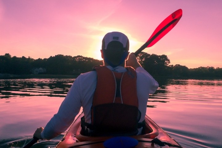 a person sitting in front of a body of water