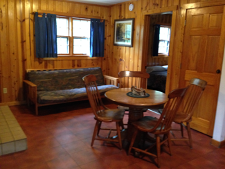 one-bedroom-living-room a room filled with furniture and a wood floor