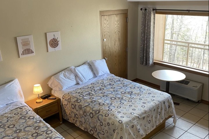 a bedroom with a bed and desk in a room