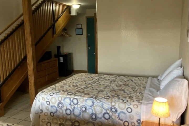 a bedroom with a bed in a room