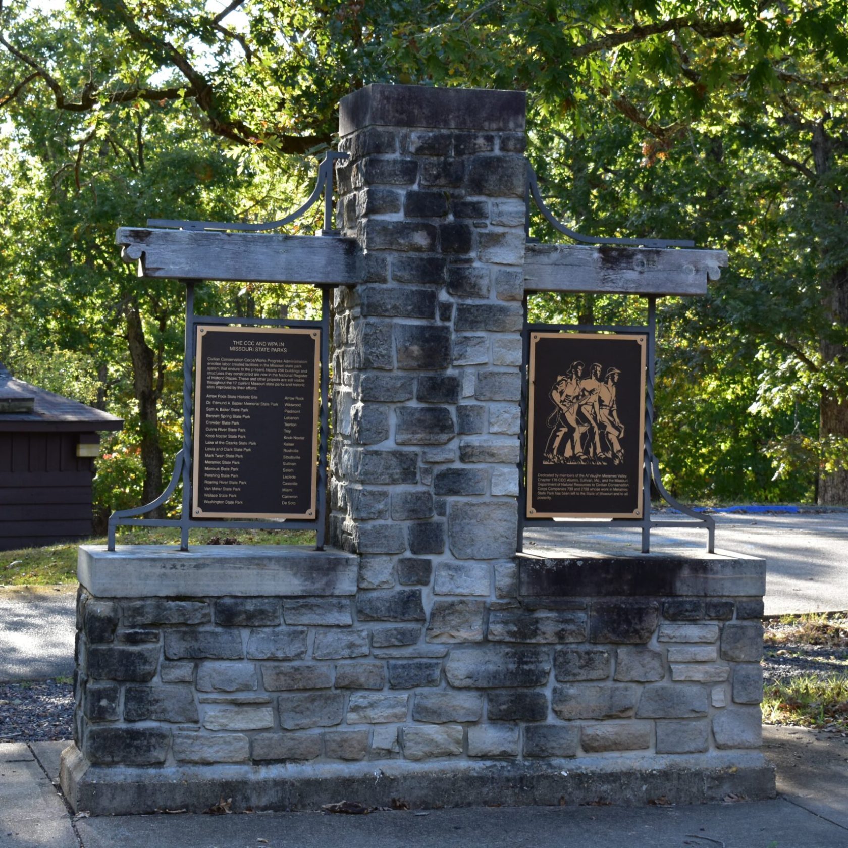a wooden statue in a park