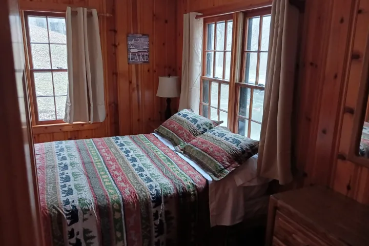 a bedroom with a bed and a window